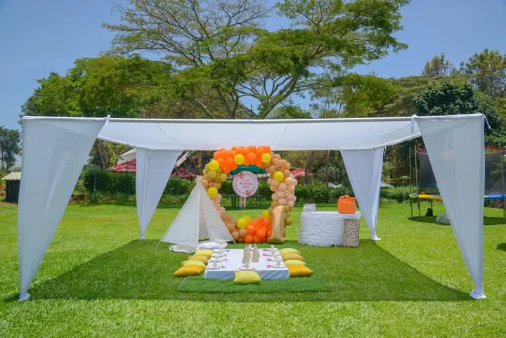 White 6m x 6m high-peak canopy tent structure set up for an outdoor event by Sherehe Events