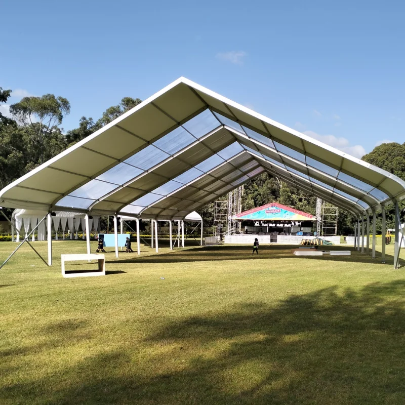 Sherehe Events crew rigging a 10m x 5m A-Frame tent frame on grass with ground stakes at a Karen residence