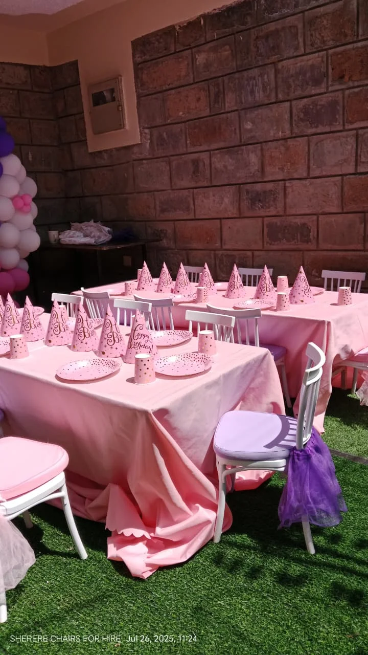"Outdoor children party rental setup featuring high peak canopy tent low height tables and child chiavari chairs on grass lawn"