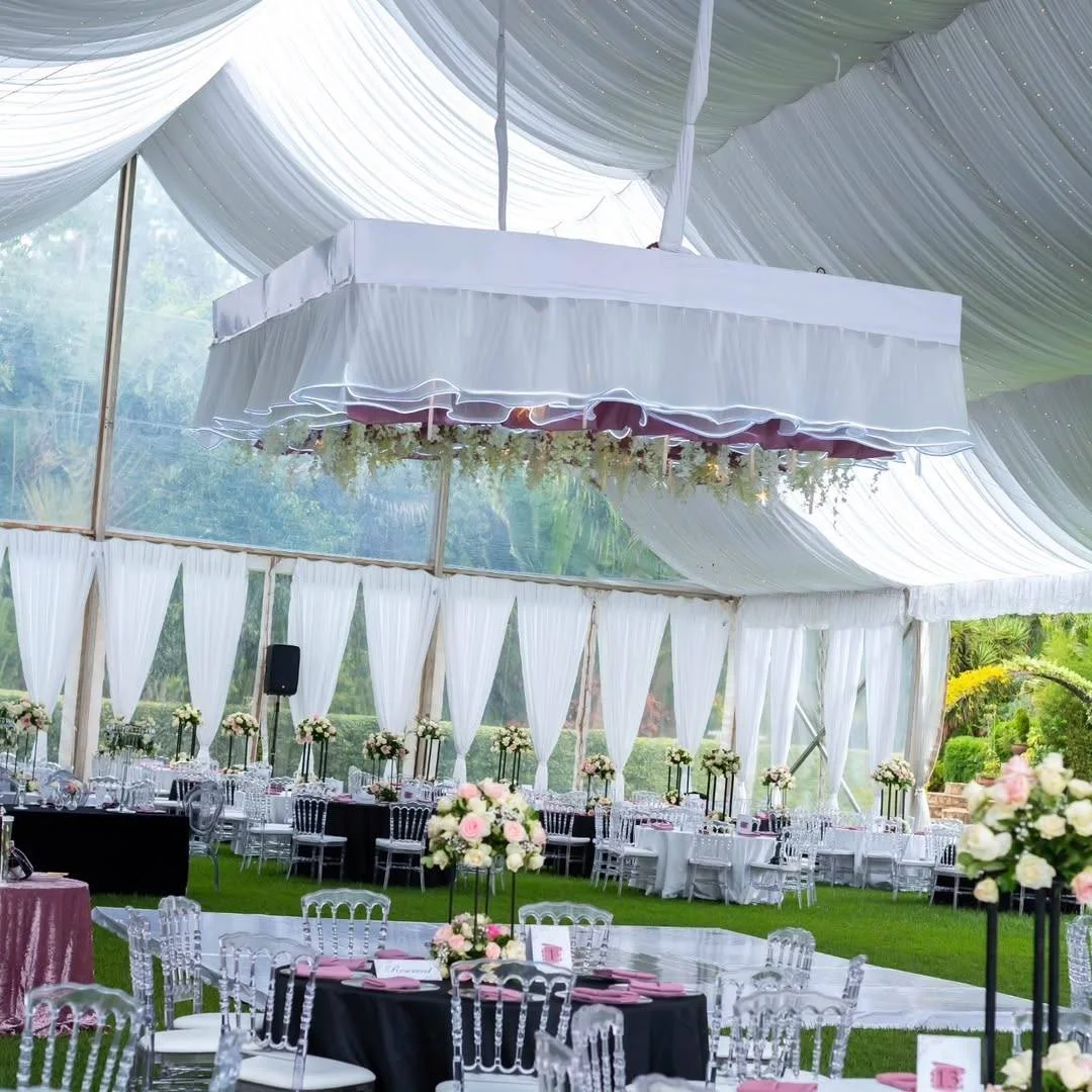 Professional party planner in Nairobi setting up a themed kids' birthday celebration with colorful balloon decorations, custom backdrop, kids' Chiavari chairs, decorated tables, party tent, lounge furniture, bouncy castle, trampoline, and entertainment equipment. Event by Sherehe Events & Rentals