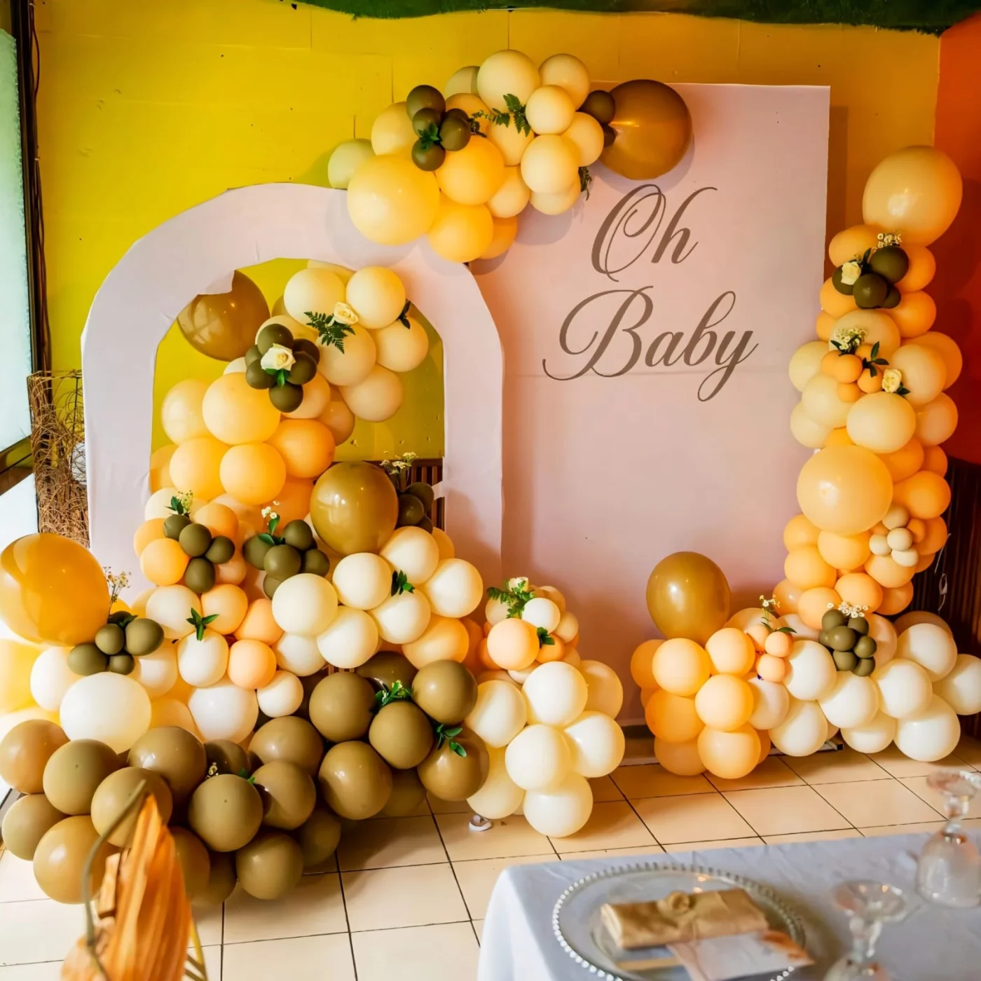 Professional balloon decoration and backdrop hire by Sherehe Events & Rentals for a kids' birthday party in Nairobi, featuring a premium three-board backdrop, organic balloon garland in blue, gold and white, cake plinths, personalized signage and elegant event styling.
