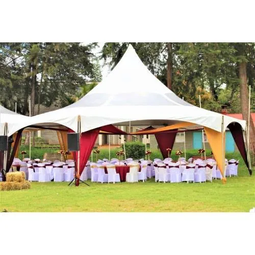 A heavy-duty white hexagon high-peak tent pitched on a manicured garden lawn with clean, tensioned canvas and sturdy structural anchoring.