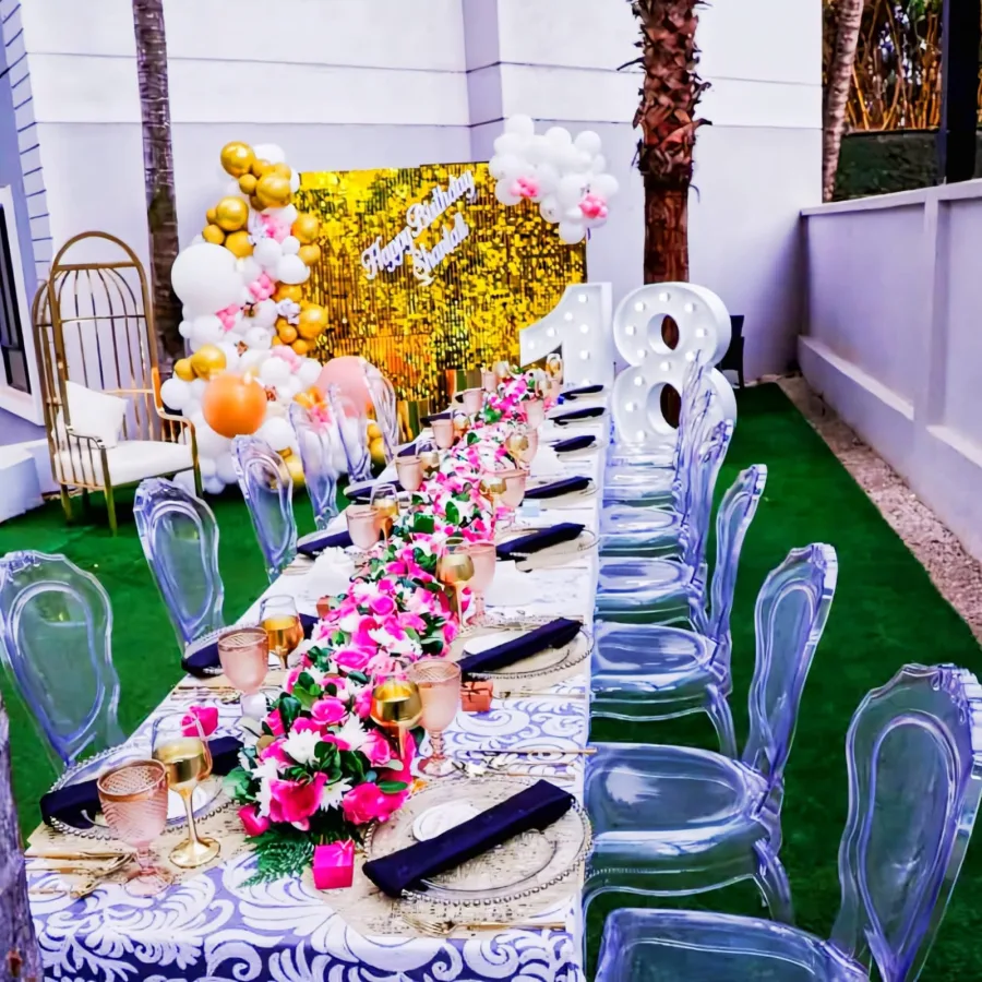 A lineup of premium polycarbonate ghost chairs for event hire showcased in transparent gold-tinted, solid glossy black, and opaque white finishes.